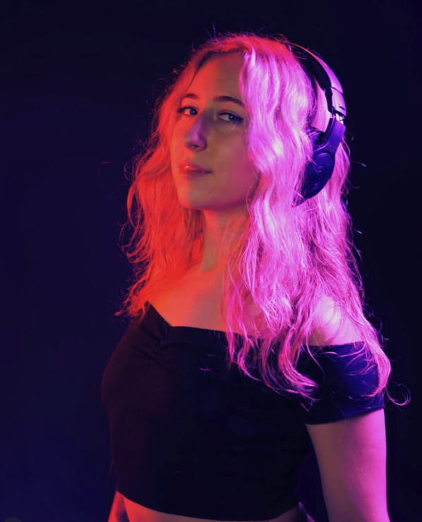 Lilah in purple and pink stage lighting